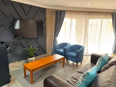 a living room with a couch and a table at Spacious stay-in 1bedroom apartment in Kempton Park