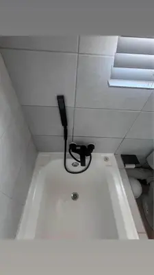 a bath tub with a hair brush in a bathroom at Cosy duplex in the heart of Midrand in Midrand