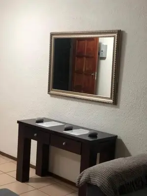 a bathroom with a sink and a mirror on the wall at Cosy duplex in the heart of Midrand in Midrand