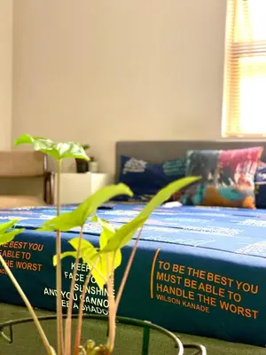 a bedroom with a bed with two signs on it at SummerPlace Guest Rooms in Modimolle