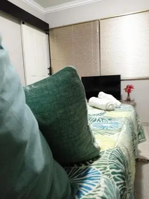 a bedroom with a bed with a green pillow on it at SummerPlace Guest Rooms in Modimolle