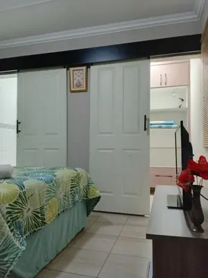 a bedroom with two white doors and a bed at SummerPlace Guest Rooms in Modimolle
