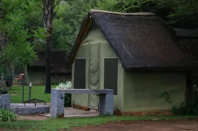 a small green building with a roof and a table at Grootgeluk in Naboomspruit