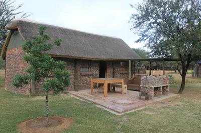 a small brick house with a table in front of it at Grootgeluk in Naboomspruit