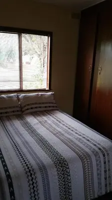 a bed in a room with a window at Grootgeluk in Naboomspruit