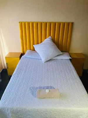 a bed with a pillow on top of it at Kanganyisa guest house in Tzaneen