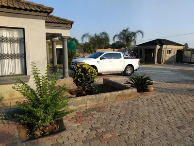 a white car parked in front of a house at Kanganyisa guest house in Tzaneen