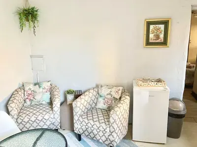 a living room with two chairs and a table at VILLA GUEST Suite in Pretoria