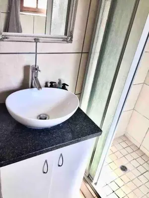 a white sink on a counter in a bathroom at VILLA GUEST Suite in Pretoria