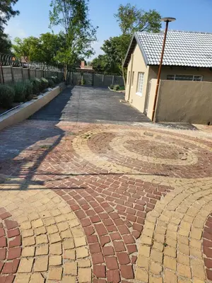 a brick driveway with a house in the background at Limewood Pool view in Sandton