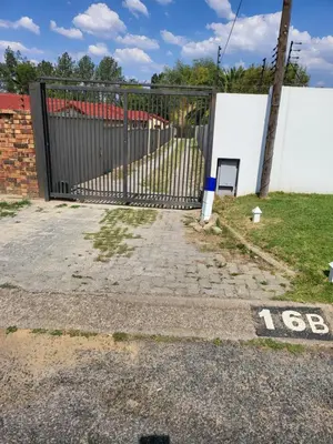 a black gate with a sign on it next to a yard at Limewood Pool view in Sandton
