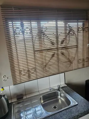 a kitchen counter with a sink and a window at American horses in Pretoria