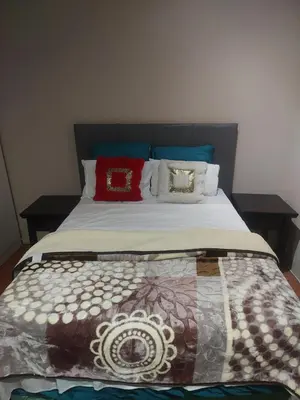 a bed with pillows on it in a room at American horses in Pretoria