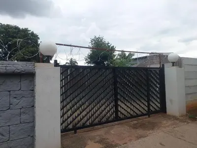 a black fence with a stone wall at American horses in Pretoria