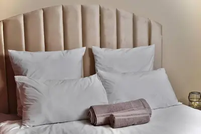 a bed with white pillows and a towel on it at SEEYAs Nest in Mataffin