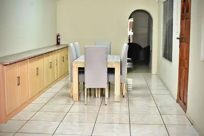 a dining room with a table and chairs in a room at SEEYAs Nest in Mataffin