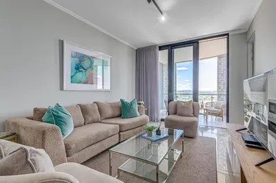 a living room with a couch and a table at Waterfall Luxury Suites in Midrand