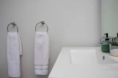 two towels hanging on a wall in a bathroom at Waterfall Luxury Suites in Midrand