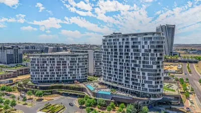 an aerial view of a tall building in a city at Waterfall Luxury Suites in Midrand