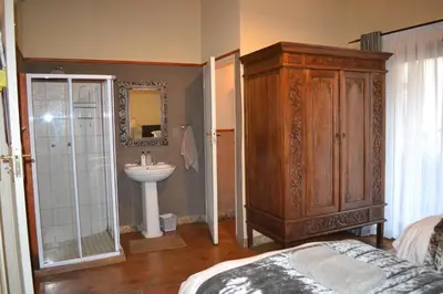 a bathroom with a sink and a cabinet next to a sink at Fox & Squirrel in Dullstroom