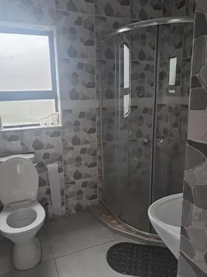 a bathroom with a shower and a toilet and a sink at Sibusisiwe in Acornhoek