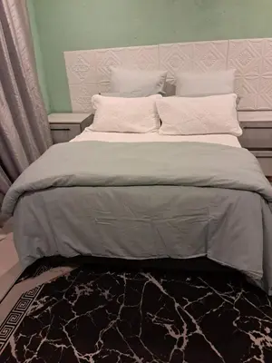 a bedroom with a large bed with a headboard at Sibusisiwe in Acornhoek