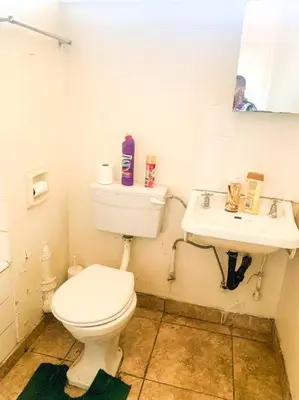 a bathroom with a toilet and a sink at Spacious, Budget-Friendly Stay in Pretoria