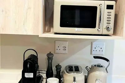 a microwave oven sitting on top of a kitchen counter at The Henlee Apartment on New - Power Backup, Gym ,Pool in Midrand