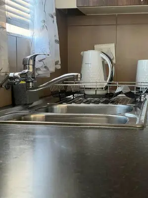 a kitchen with a drying rack on a sink at Homie my home in Centurion