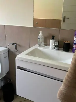 a bathroom with a white sink and a mirror at Homie my home in Centurion