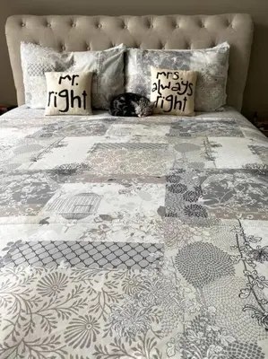 a cat laying on top of a bed at Casa Galetti in Hartbeespoort