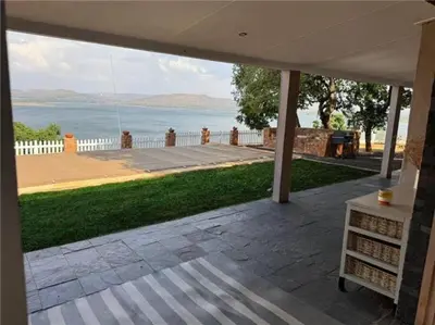 a patio with a view of the water at Casa Galetti in Hartbeespoort