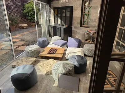 a group of ottomans and chairs and a table at Casa Galetti in Hartbeespoort
