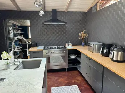 a kitchen with a stainless steel stove and a sink at Casa Galetti in Hartbeespoort