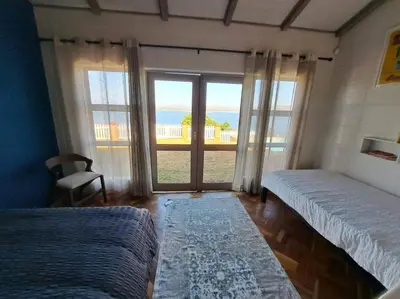 a bedroom with two beds and a view of the ocean at Casa Galetti in Hartbeespoort