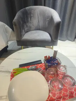 a living room with a chair and a table at Kwena Guesthouse in Groblersdal