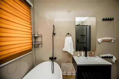 a bathroom with a tub and a sink and a shower at Luxuriously finished 2 bedroom in Midrand