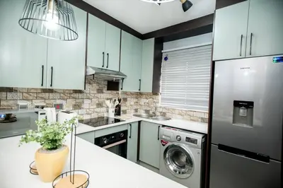 a kitchen with a refrigerator and a dishwasher at Luxuriously finished 2 bedroom in Midrand