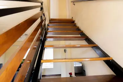 a staircase in a building with wooden railings at Pristine in Centurion