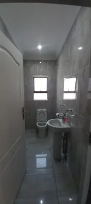 a bathroom with a toilet and a sink at Budais guest lodge in Kempton Park