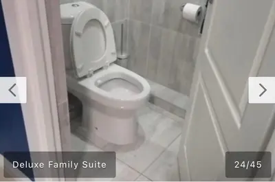 a bathroom with a white toilet in a bathroom stall at Budais guest lodge in Kempton Park