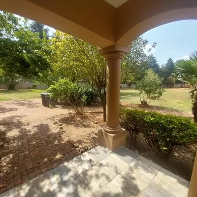 a porch with a view of a yard at Budais guest lodge in Kempton Park