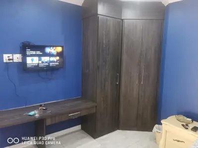 a bathroom with a tv on a blue wall at Budais guest lodge in Kempton Park