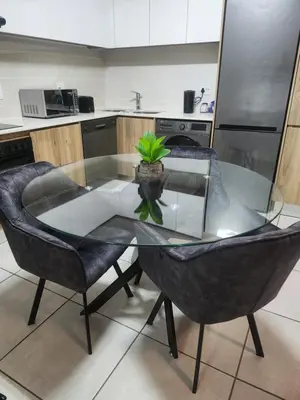 a glass table with a potted plant on it in a kitchen at Cozy home at The Blyde in Pretoria
