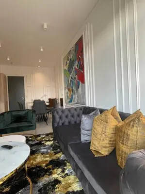 a living room with a couch and a table at El Mayor Deluxe Suite MENLYN MAINE in Pretoria