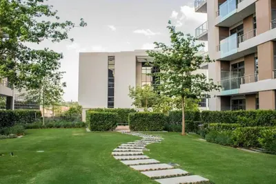a garden with a stone path in front of a building at El Mayor Deluxe Suite MENLYN MAINE in Pretoria
