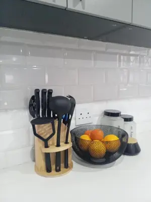 a kitchen counter with a bowl of fruit and utensils at Luxury Escape OR Tambo International in Kempton Park
