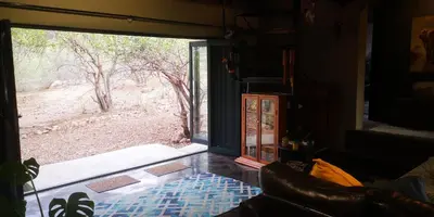 a living room with a large sliding glass door at Lions Gate in Marloth Park