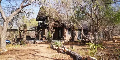 an old house in the middle of some trees at Lions Gate in Marloth Park