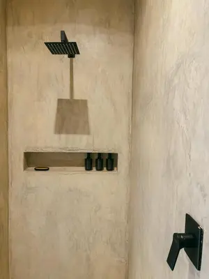 a bathroom with a shower with a light on the wall at Leopard's Villa, Marloth Park in Marloth Park